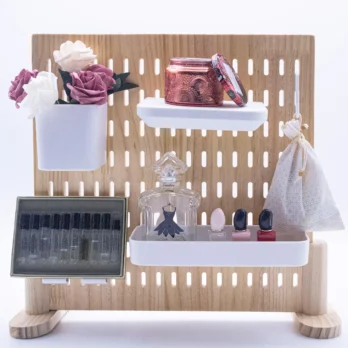 Flowers, candle, perfume on the Wooden Desk Pegboard